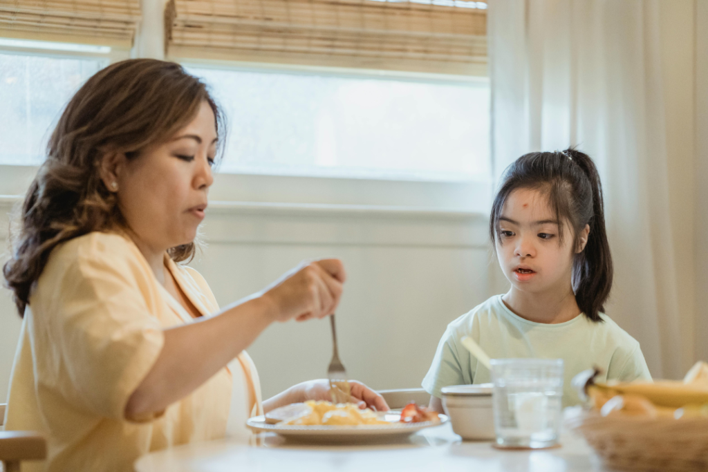 Carer helping a participant during mealtime in respite care Masric Health Registered NDIS Service Provider Geelong and Surf Coast 
